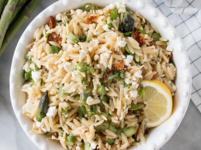 Asparagus and Sundried Tomato Orzo Pasta Salad in a white serving bowl