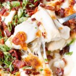 Cheesy Pierogies Casserole with cheese stretched between pierogies