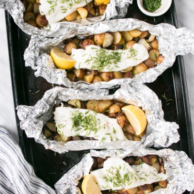Cod, Chorizo and Potato Foil Packets on a baking tray