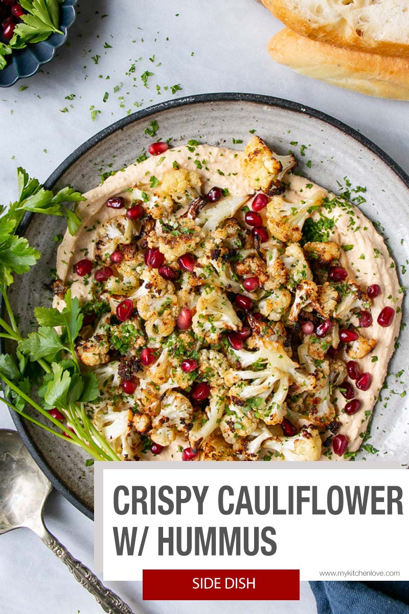 Crispy Baked Cauliflower on a bed of smooth garlicky hummus, all topped with juicy jewelled pomegranate seeds and chopped parsley. An elegant dish that is unbelievably easy and quick to make. via @mykitchenlove