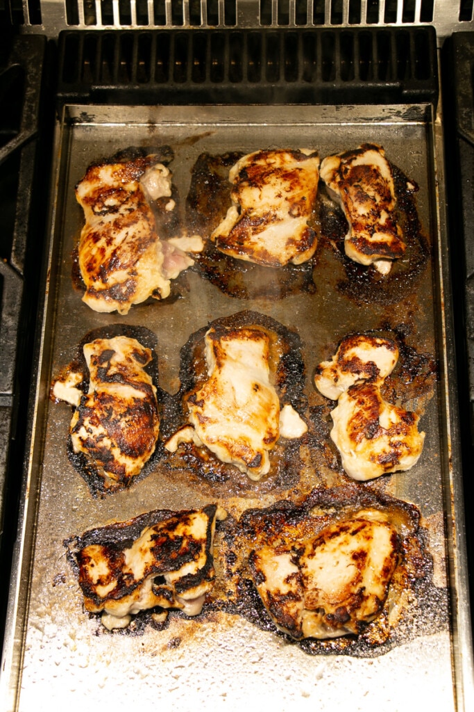 Lemongrass Chicken being seared on a griddle. 