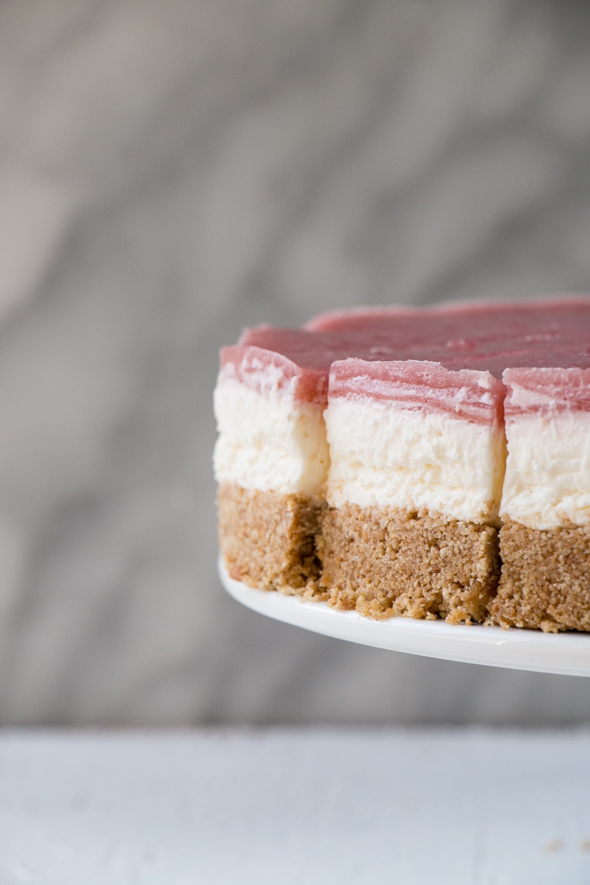 side angle photo showing layers of a No Bake Rhubarb Cheesecake