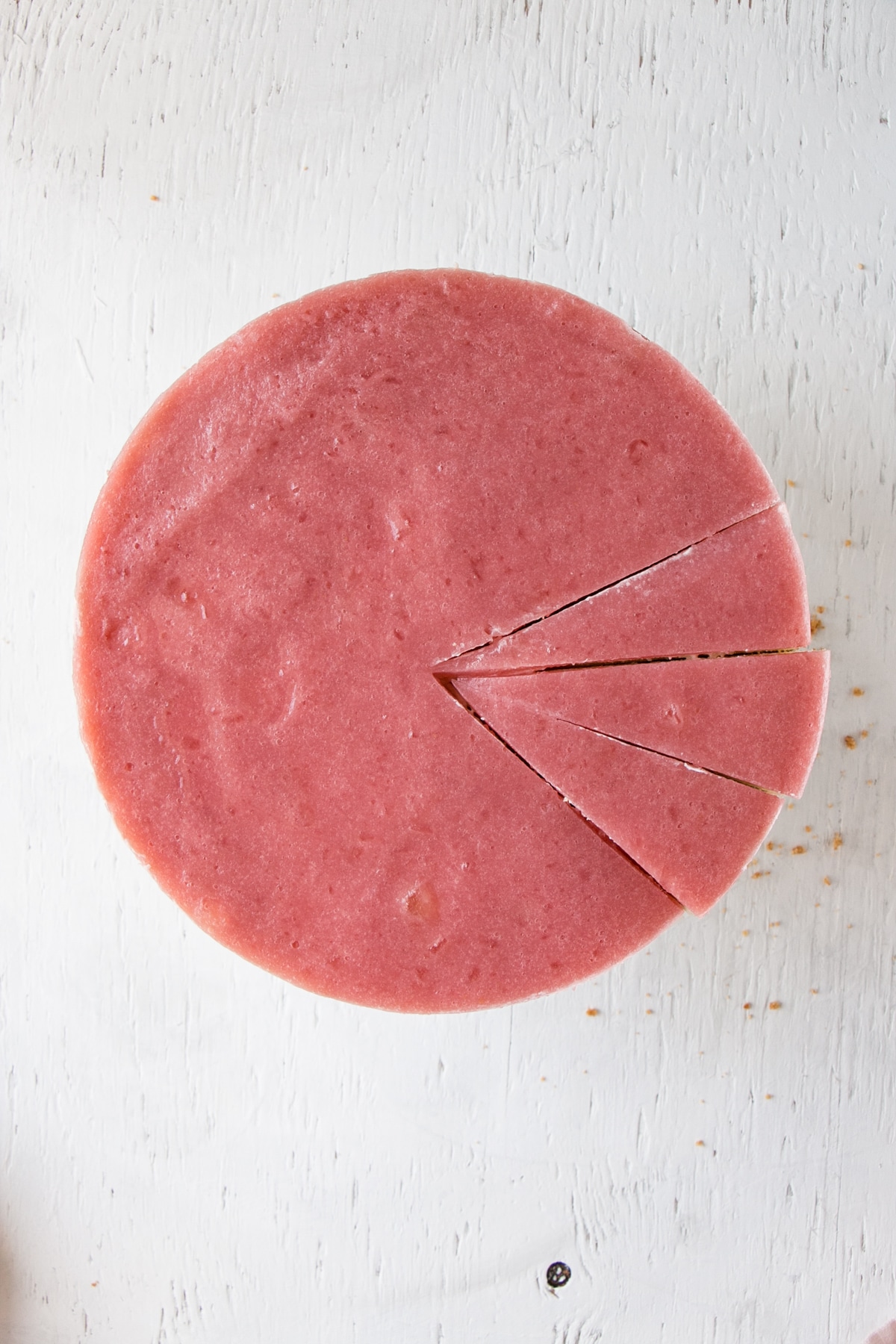 top down view with a few slices cut of No Bake Rhubarb Cheesecake